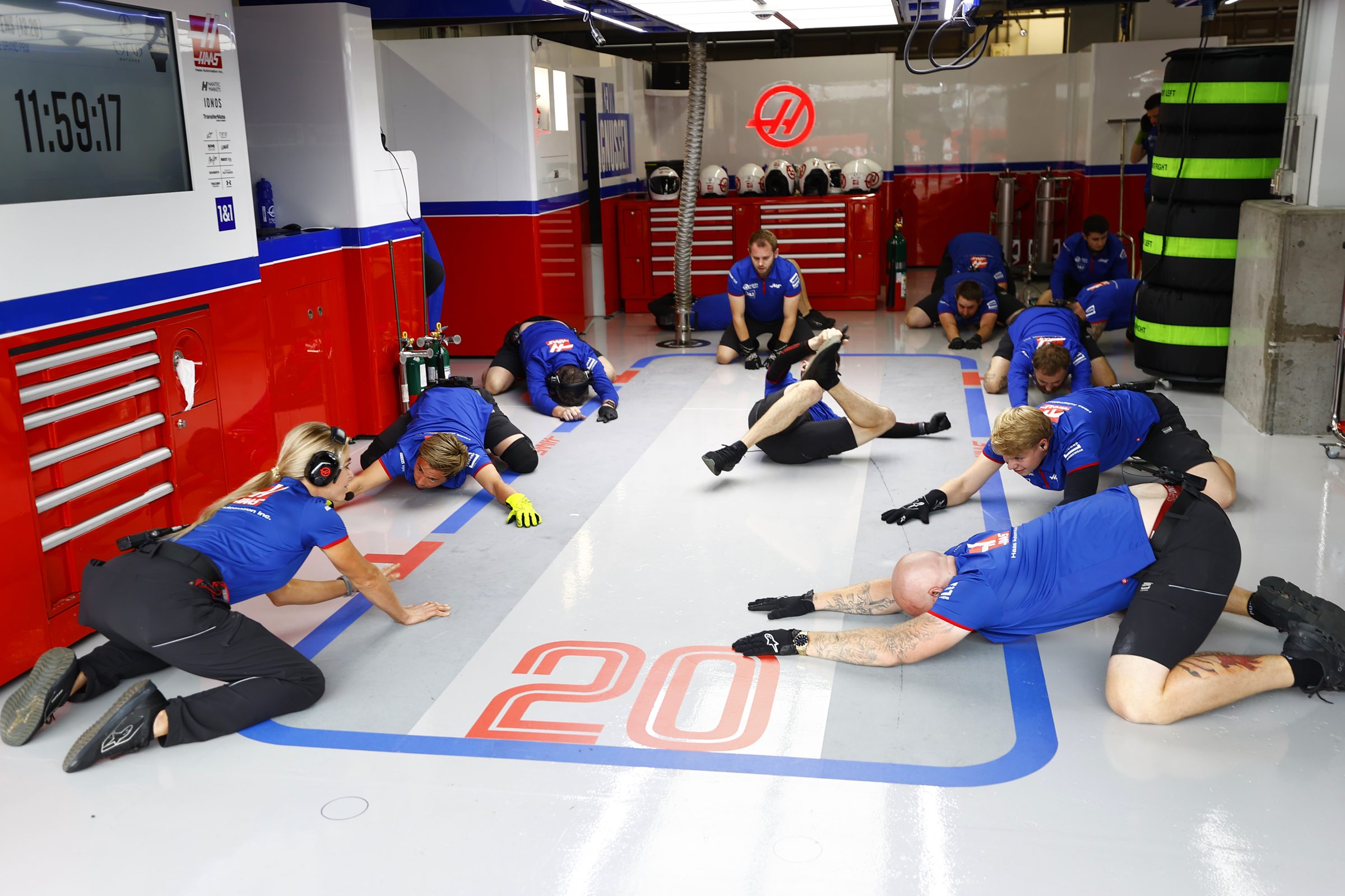 Haas pit crew warming up before a session